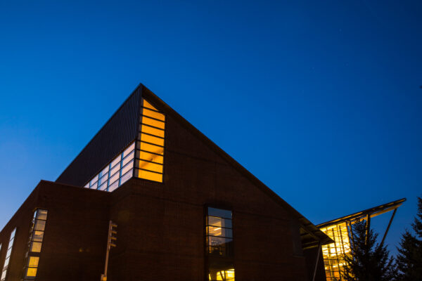 uw bothell cascadia college library with lights on at twilight