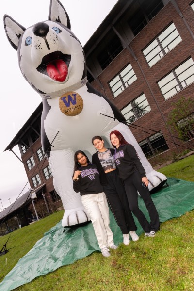 Students posing in front of inflatable husky