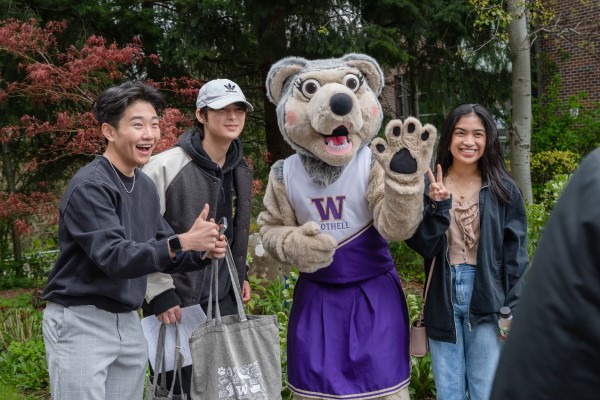 Group of students posing with mascot, Holly the Husky
