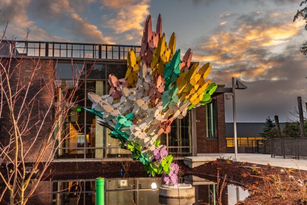 A colorful sculpture in front of a building