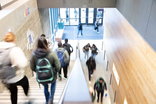 A group of people walking down a staircase.