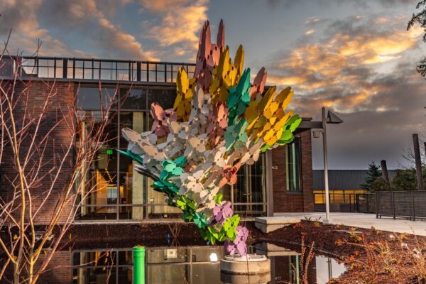 A colorful sculpture in front of a building.