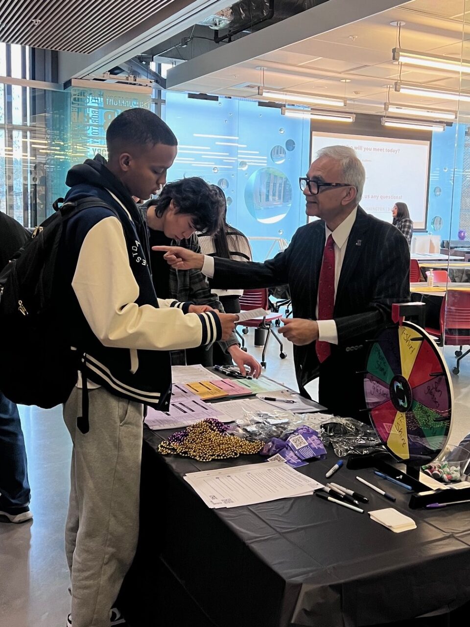 The Dean of the School of Business talks with a student at the Pathways event. 