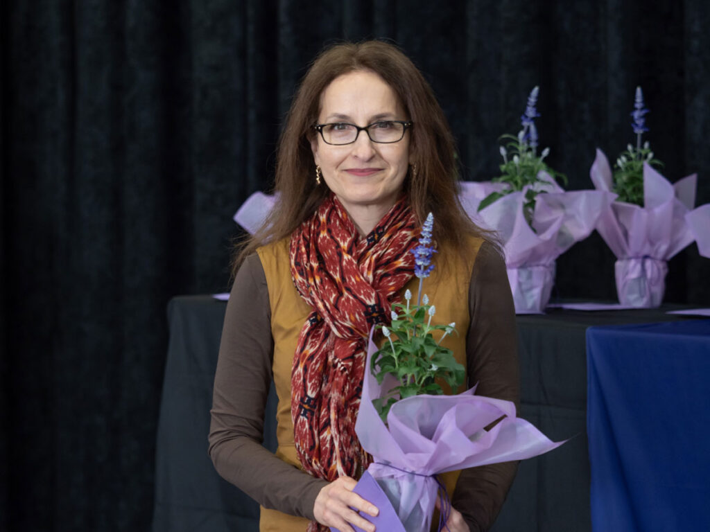 A person holding a bouquet of flowers.