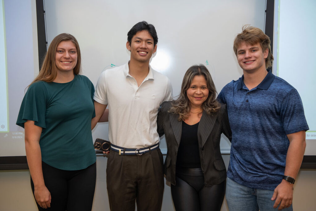 Four people pose for a photo.