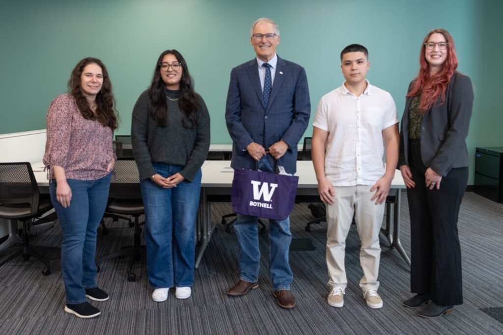 Five people pose for a photo.