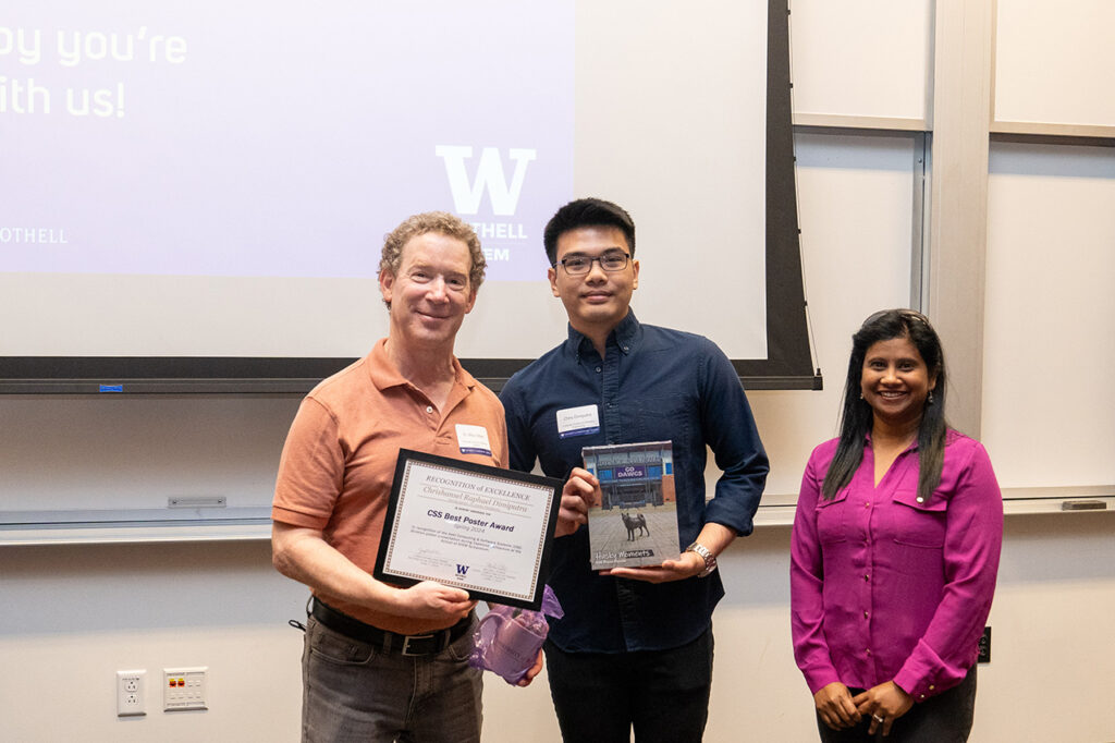 Computing & Software Systems division chair Michael Stiber posing with students who received their award. 