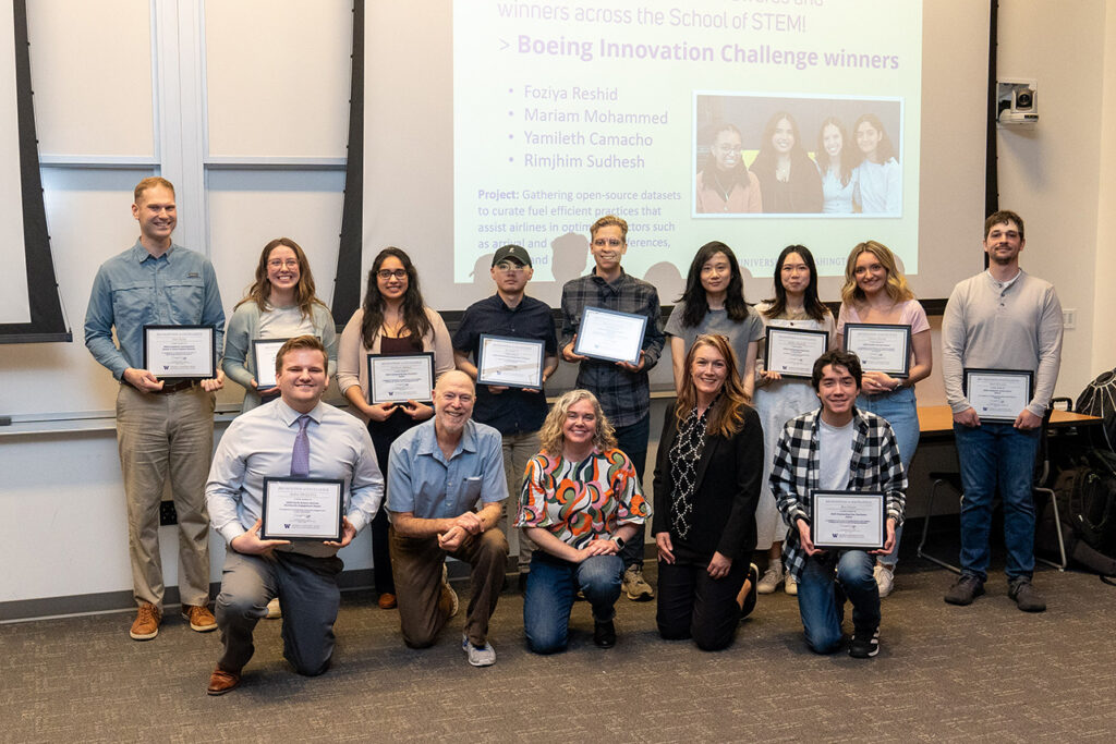 Physical sciences division chair Daniel Jaffe and associate teaching professor Heather Galindo posing with students who received their awards. 