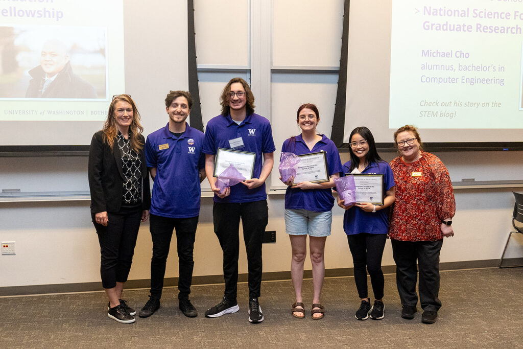 Interim dean Jennifer McLoud-Mann posting with student assistants from the capstone symposium after they received their awards. 