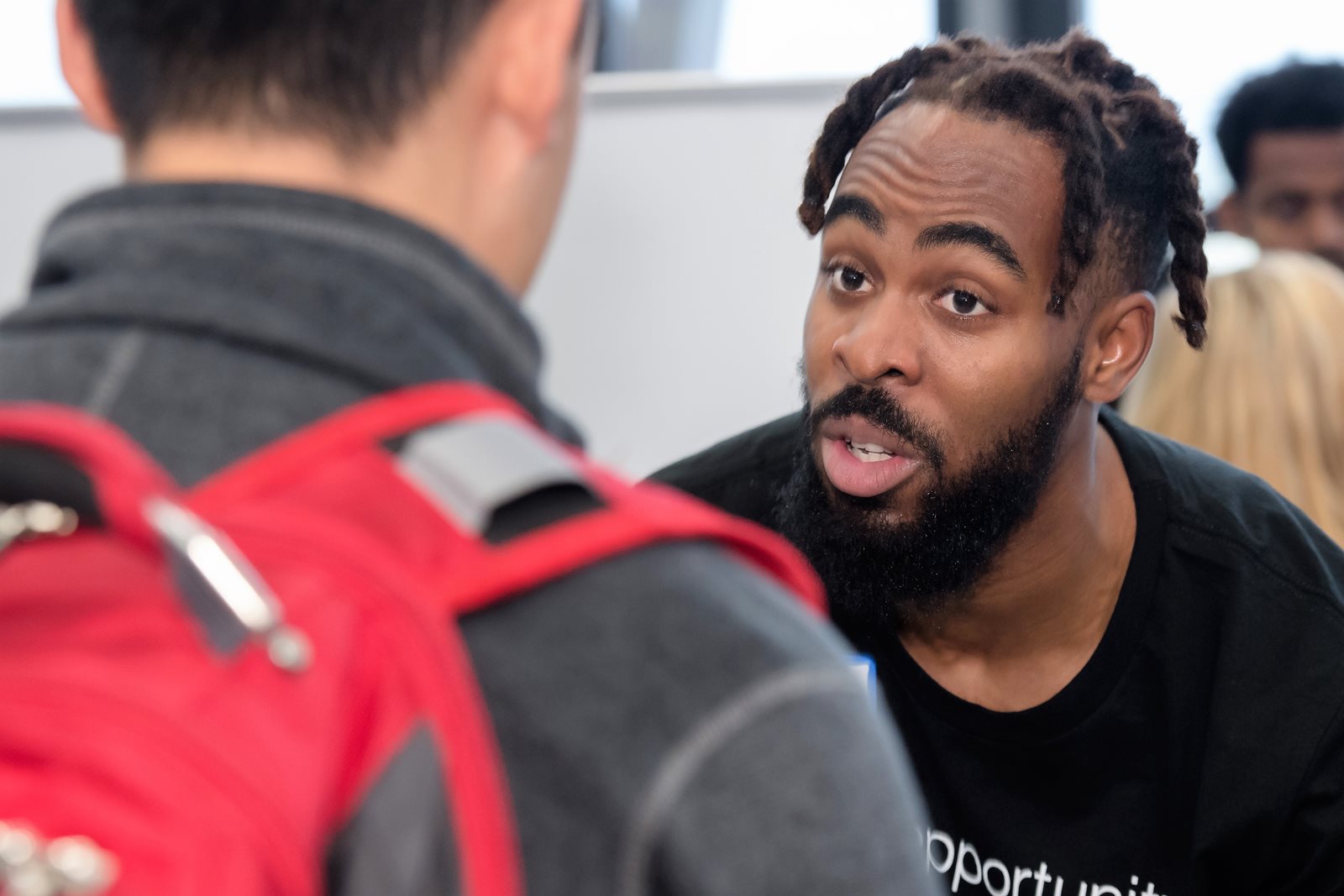 Patrick Okocha talks to student.