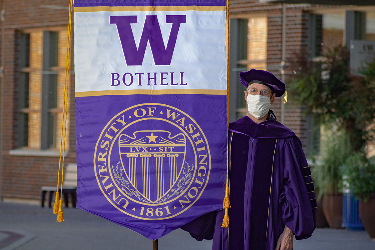 Professor David Socha holding the UW Bothell banner