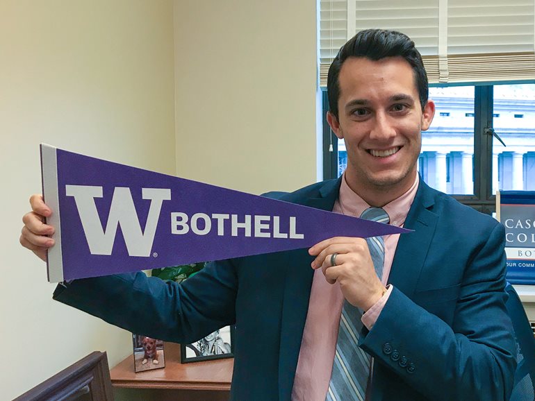 Jared Mead holding UW Bothell pennant