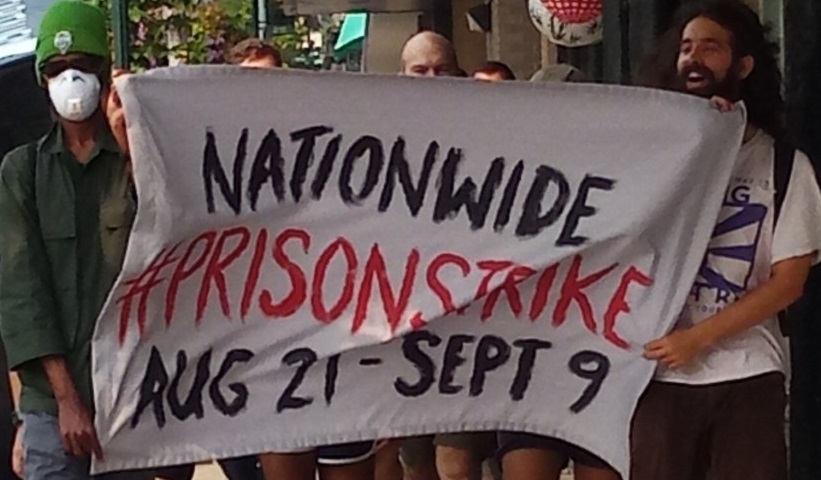 protesters holding prison strike banner